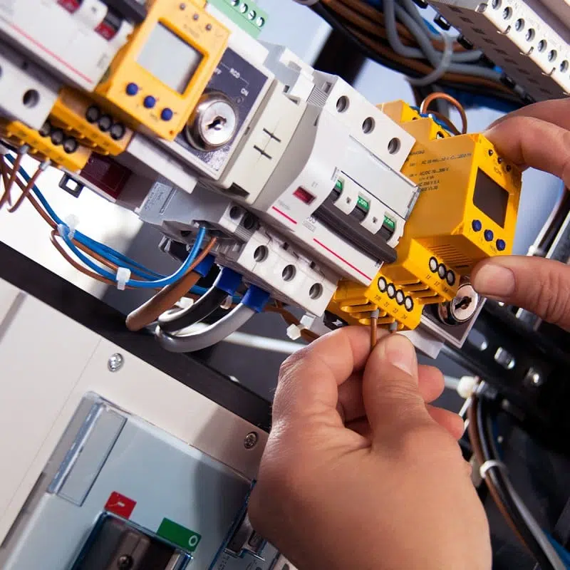 Close-up of hands on an electrotechnical system